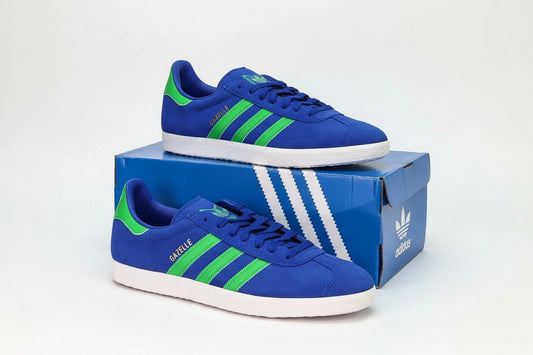 Adidas Gazelle Men's Shoes in Blue Green on a box, featuring a retro athletic design and classic silhouette.