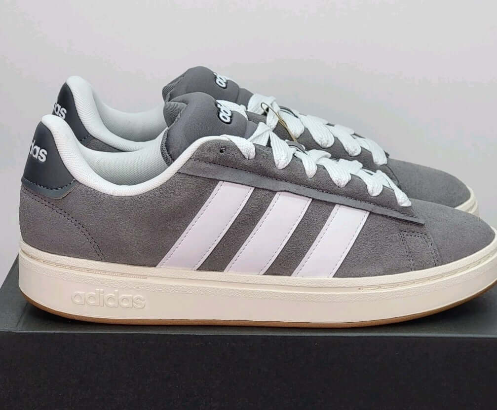 Adidas Grand Court Alpha sneakers in gray and white, featuring classic court design and casual comfort.