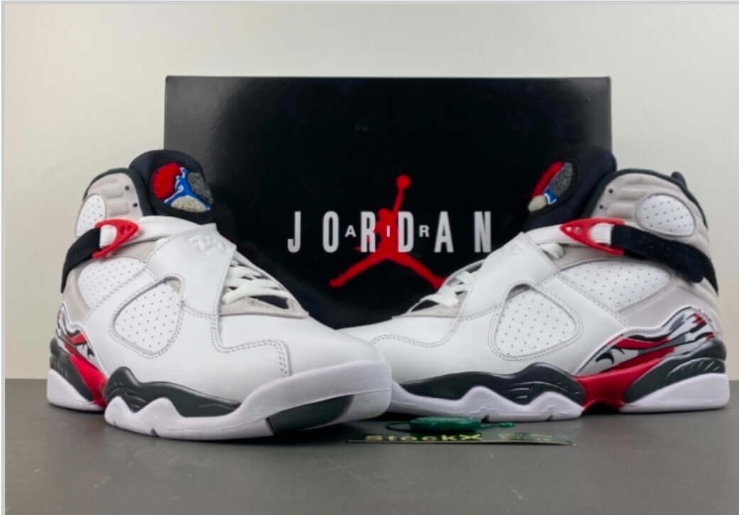 Air Jordan 8 Bugs Bunny – White / Black / Red sneakers displayed with the Jordan logo in the background.