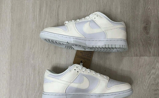 Nike Dunk Low Next Nature Sail White sneakers showcasing a clean Sail White leather upper with beige accents